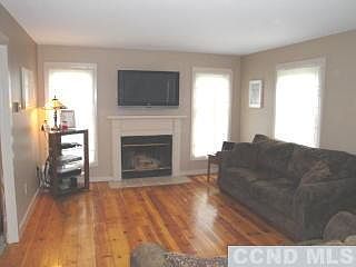 Living room has wood burning fireplace.