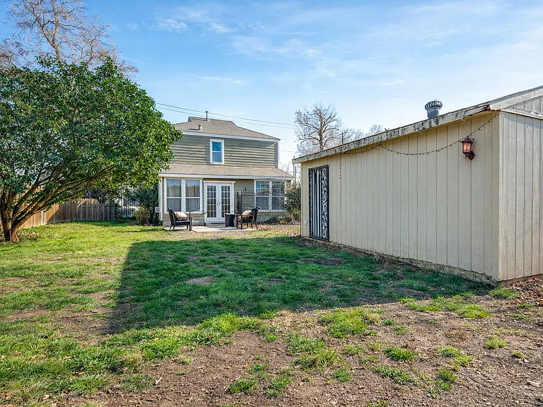 Fully fenced in yard. The garage is the building on the far right of the photo.