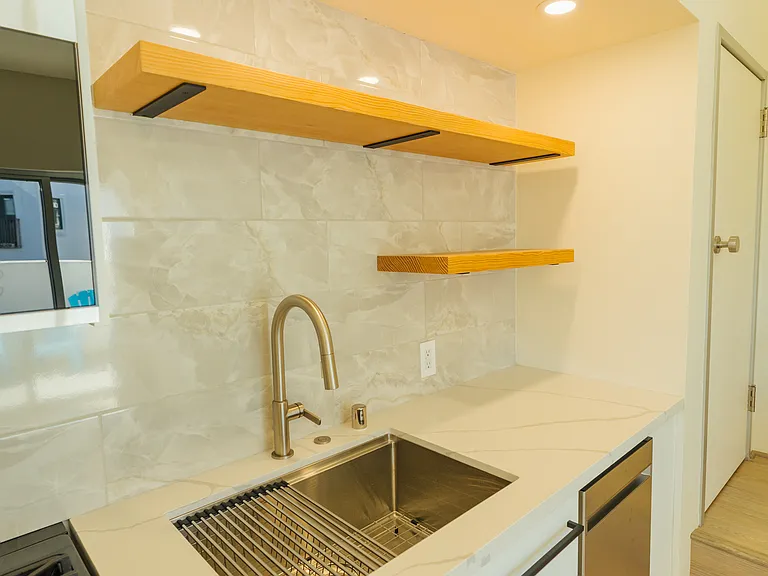 Custom cabinetry, tiled backsplash. Includes stove, oven, microwave and dishwasher.