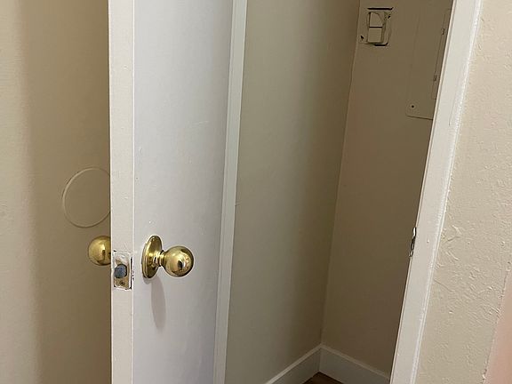 Closet space located in kitchen behind the entry door.