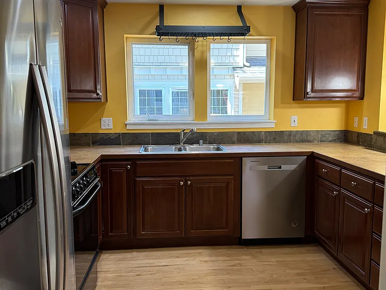Large modern kitchen on the Main level updated with brand new SS Whirlpool Dishwasher and side by side SS Whirlpool fridge-freezer with water & ice dispenser