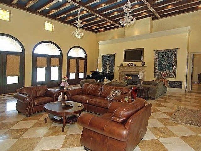 Living room is graced with travertine floors