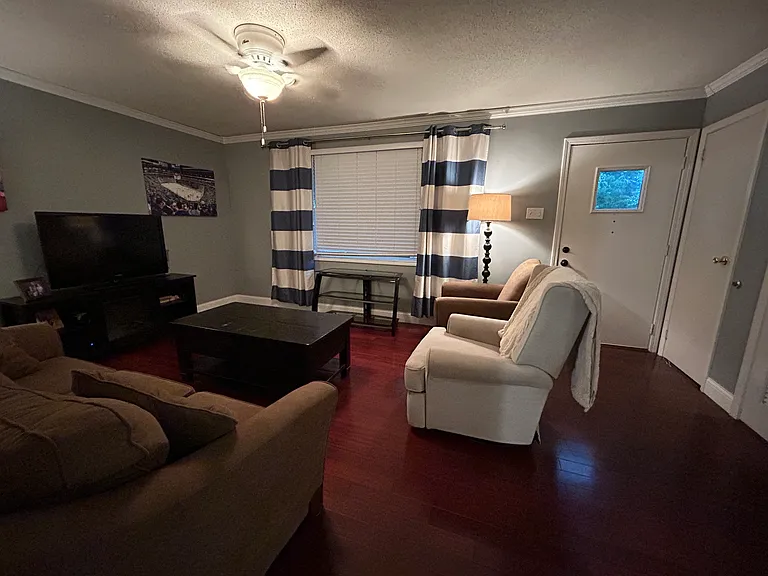 View of the front living space from the threshold to the kitchen.