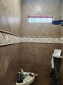 Primary bathroom has a tiled walk in shower
