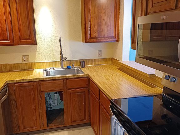 Kitchen with newer stove, microwave, side by side refrigerator, and dishwasher.
