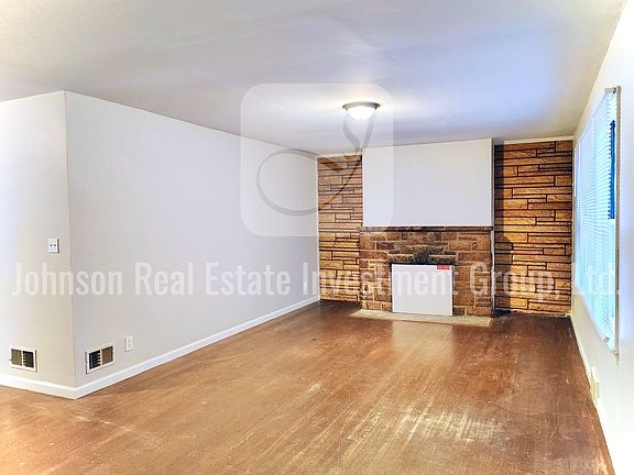 Spacious living room with stone accent wall