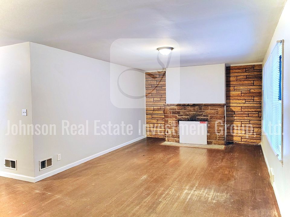 Spacious living room with stone accent wall