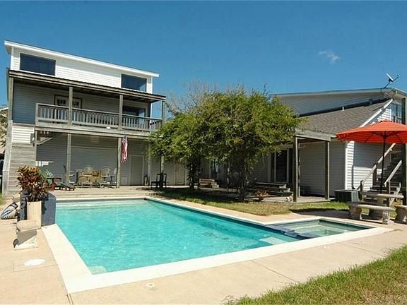 POOL WITH BACK VIEWS OF UNFINISHED APARTMENT OVER GARAGE AND BACK OF MAIN HOUSE
