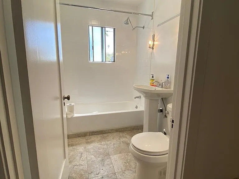 Bathroom with shower/tub combo. Remodeled tub and shower. New sink and toilet.