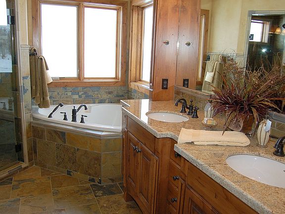 Master bath with granite counters, slate floors, and huge walk in closet