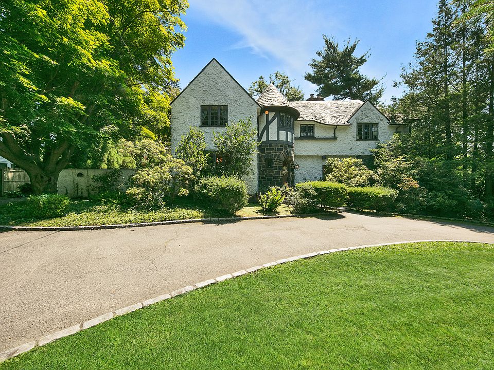 Handsome and elegant with a generous semi-circle dirveway, this timeless Tudor is located in the beloved neighborhood known as Elmsmere Estates. 