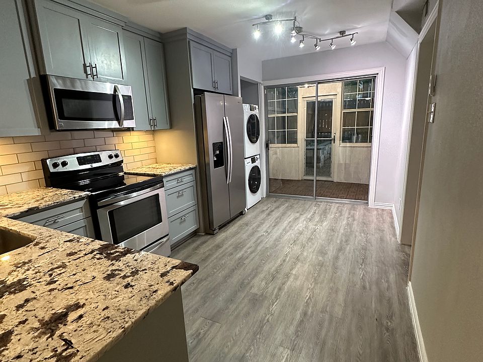 Kitchen with beautiful granite countertops and newly painted cabinets. Washer & dryer, stainless steel appliances.