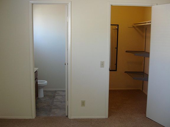 Master bedroom facing half bath and walk in closet