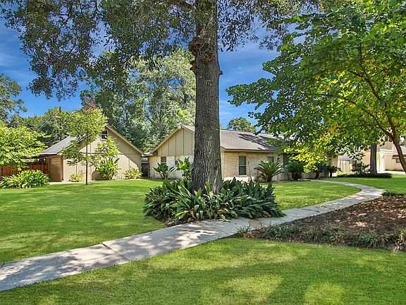Amble up to your entry on your long, shady sidewalk.
