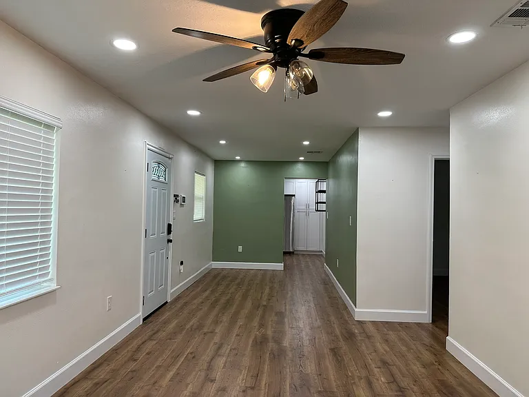 view from the living room towards the dining room and kitchen