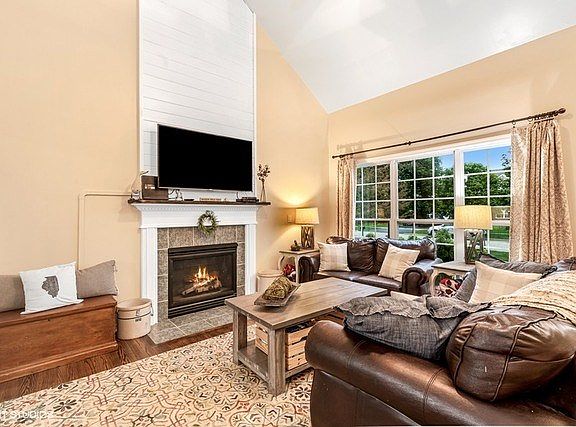 Decorative wood & ceramic tile surround this gas log fireplace!