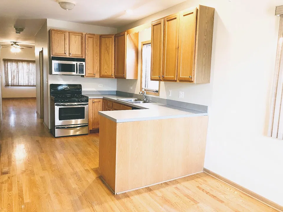 Kitchen features stainless fridge, stove/oven, microwave range hood and dishwasher