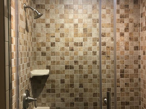 Tile shower with sliding glass door