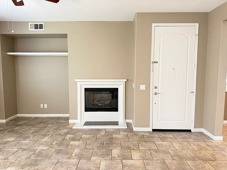 Living room with gas fireplace and entrance door