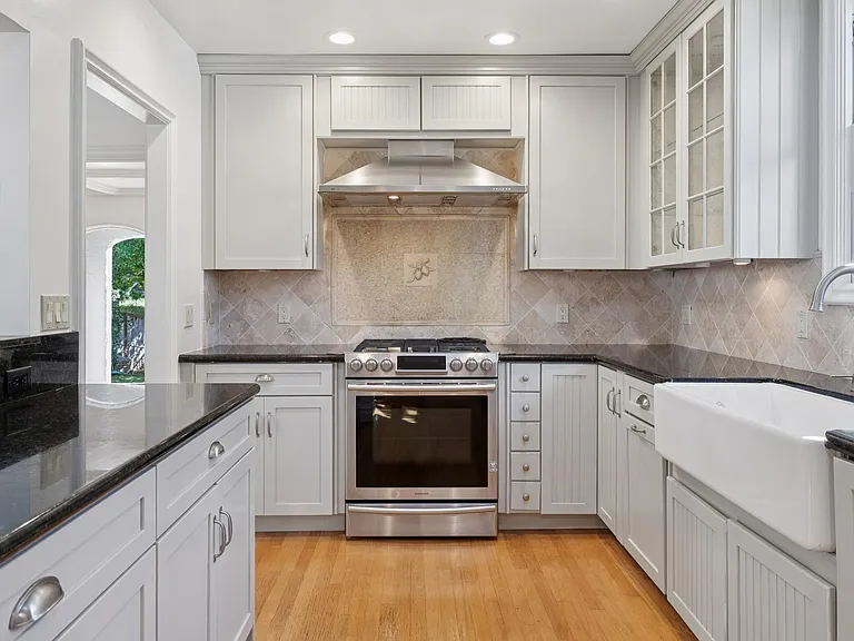 Chef's kitchen with stainless appliances, marble countertops, an abunance of cabinet space.