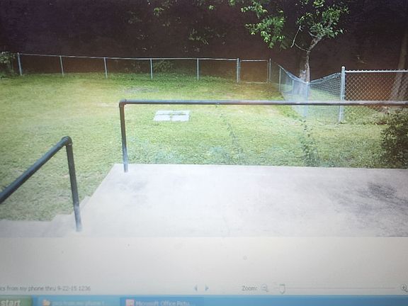 Back yard and patio. Access out kitchen door. There is a basement. Entry is from the outside.