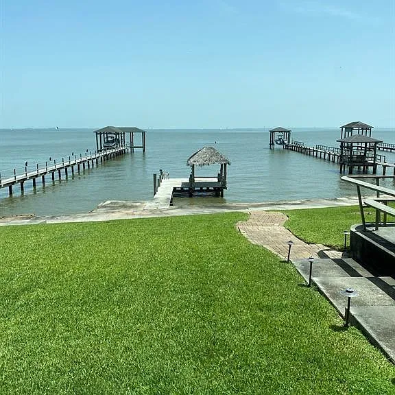 The bay-facing backyard. **Please note that the effects of several hurricanes this past summer unfortunately destroyed the pier. We are currently working on the redesign and rebuild of the pier.**