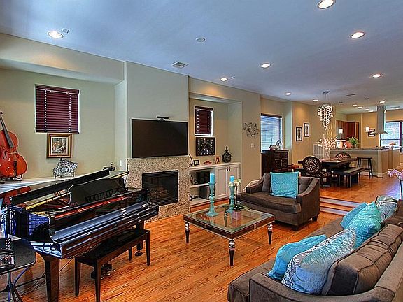 View of Living Room. Note Gas Log Fireplace with Granite Surround.