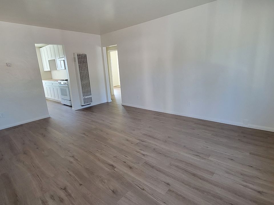 Spacious living room with wall furnace.
