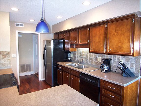 Gourmet Kitchen with hardwood floors and tiled back splash.
