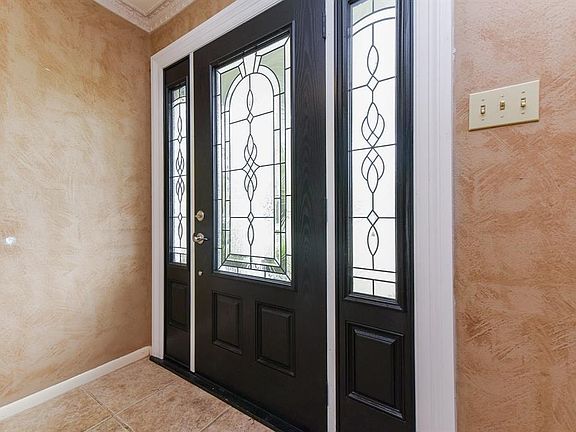 Beautiful leaded glass front door greets you as you enter