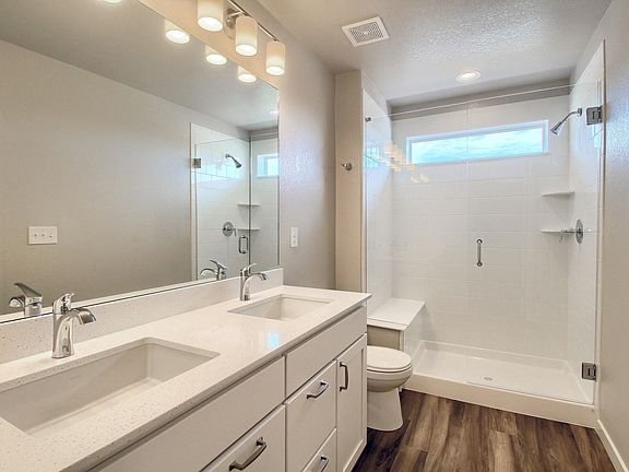 Master suite bathroom - dual sink, frameless Euro shower with bench and tile come standard