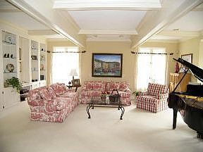 Formal living Room with custom built ins and coffered ceiling
