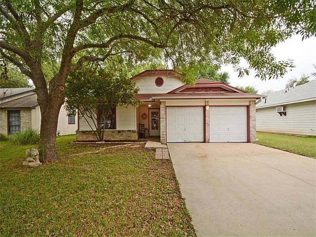 Adorable single story home in Woodstone Village with large trees in front and back!