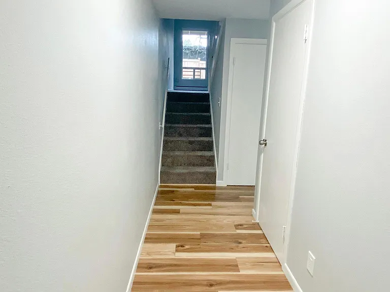 Entry- stairs lead up to the living room and to the right is the kitchen and dining areas