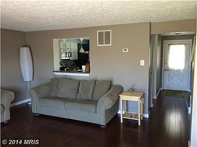 Living room toward kitchen, foyer and front door