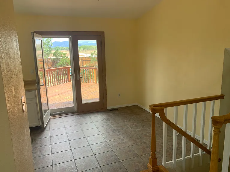 Dining area with access to deck and view of mountains
