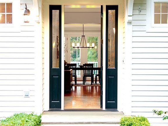 Entry with stunning formal staircase and beautiful painted millwork.