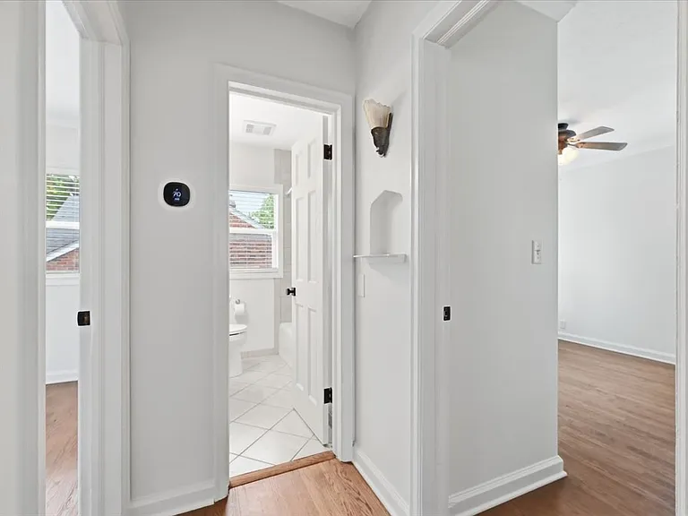 Main floor hallway with Ecobee thermostat. Fresh paint, new interior doors, new doorknobs.
