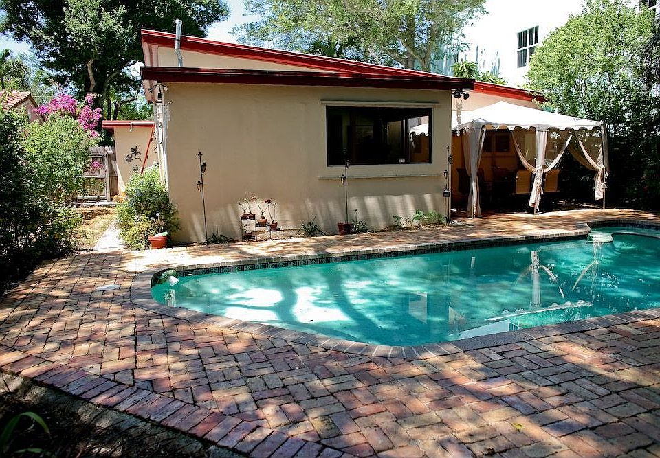 Backyard, small sunroom in the back of the home, sliding glass doors.. 