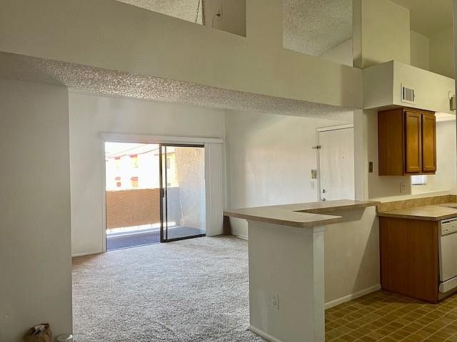 high ceilings in the living room, kitchen and dining area