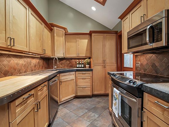 Updated kitchen with high ceilings and skylights, stainless appliances, and access to backyard with hot and cold water hose taps outside as well.