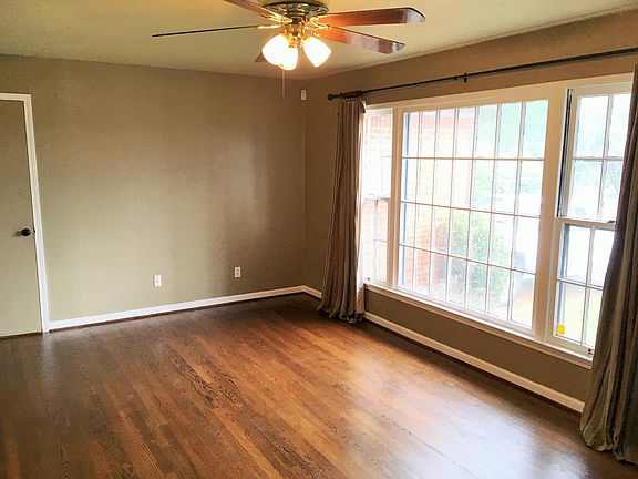 Living Room looking towards front window and garage door