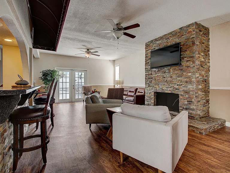 Charming living room featuring a modern fireplace, sleek hardwood floors, and a cozy seating area with stylish furniture.