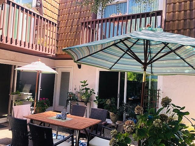 The front door inside the cozy fenced-in courtyard. Bedroom patios above.