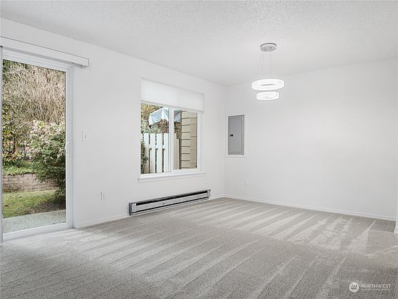 Large window & slider off the dining area.>