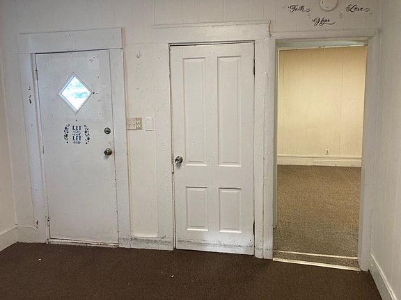 Front door and living room closet (and entry to bedroom).