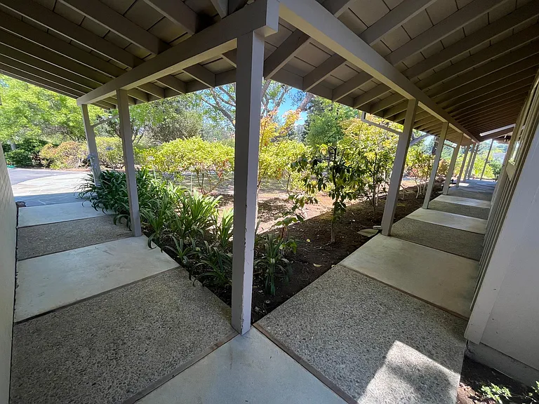 Covered walkway connecting the house to the detached garage.