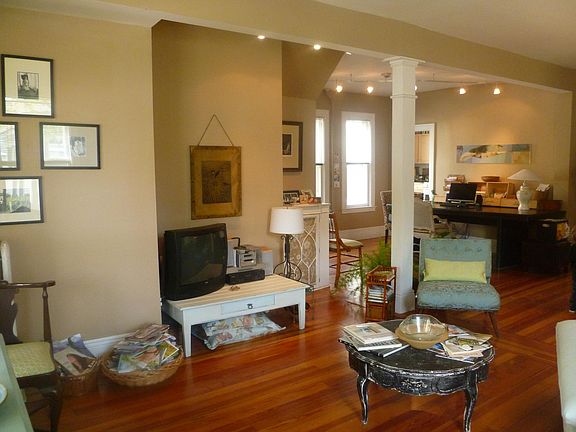 Main living space, open floor plan. Walls now freshly painted white.