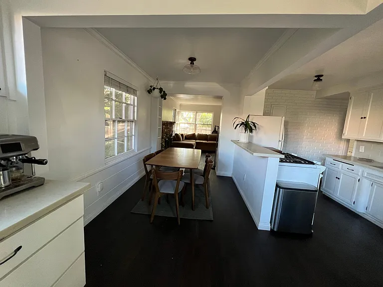 View of the dining area and kitchen from the back patio door