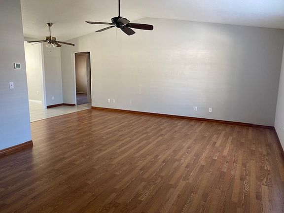 Lovely livingroom with vinyl wood like plank flooring. Large sunny picture window. Open to kitchen family area.